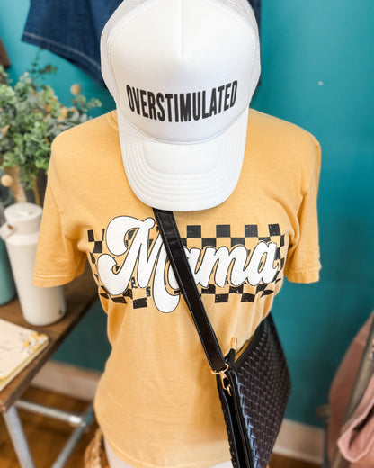 Mannequin wearing a yellow t-shirt with 'Mama' print and an 'OVERSTIMULATED' cap.