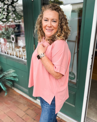 a rose colored scuba style top with a hi-low split hem.