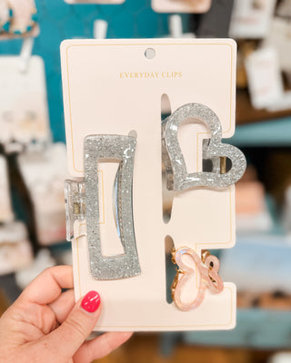 a set of three glitter claw clips in various shapes