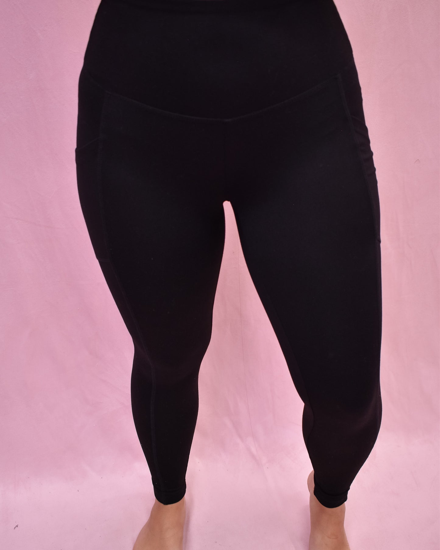 Black leggings on a pink background
