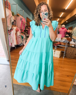 a seersucker tiered midi dress with indigo blue piping