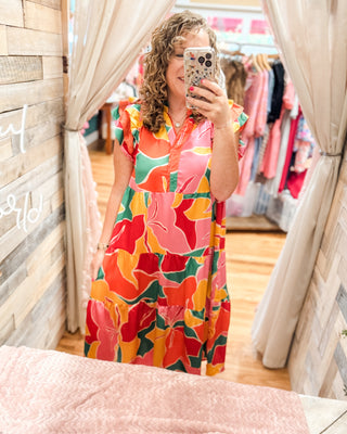 A bright patterned midi dress with ruffle cap sleeves.