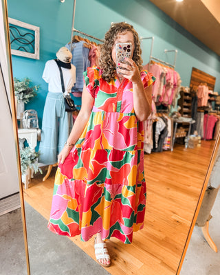 A bright patterned midi dress with ruffle cap sleeves.