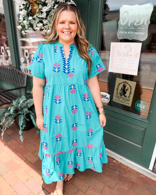a teal midi dress with embroidered floral patterns 