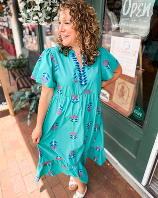 a teal vneck midi dress with embroidered floral patterns 
