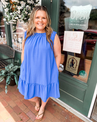 a blue sleeveless drop hem dress with scrunched sleeves and neckline.