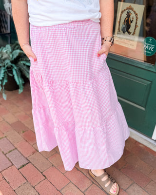A gingham tiered pink and white checkered midi skirt