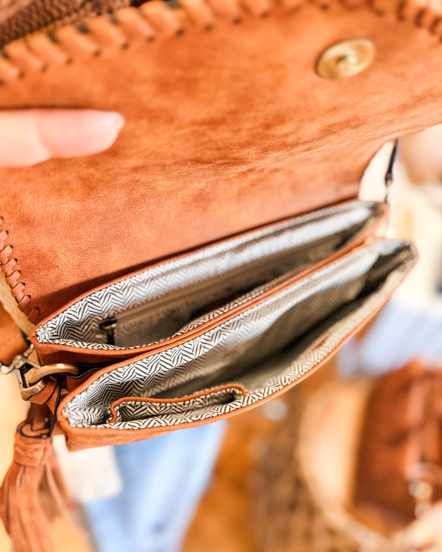 Close-up of a brown leather wallet with a zipper, showing the interior.