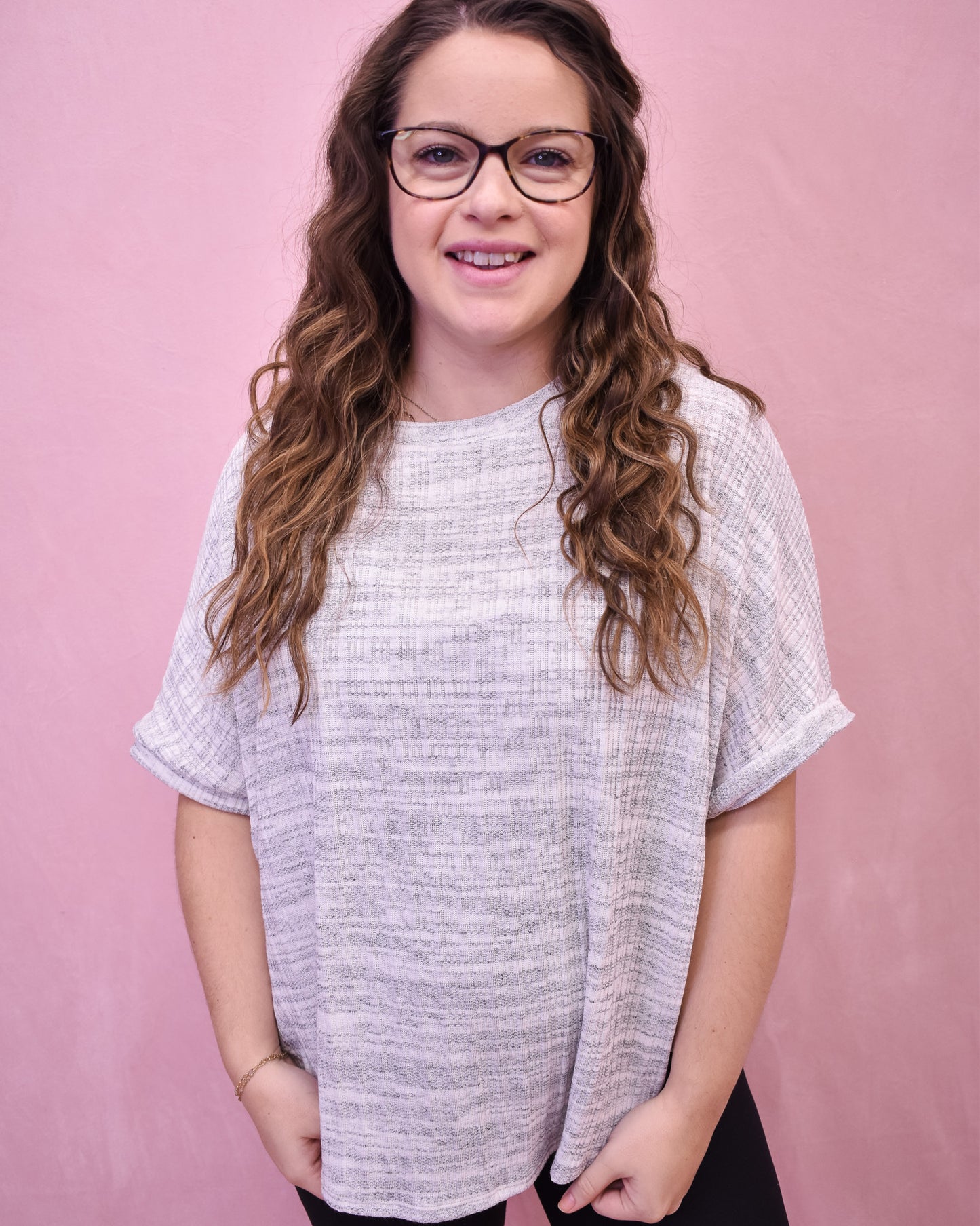 Lightweight heathered gray top with a loose fit and batwing style