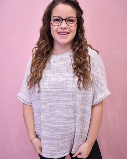 Lightweight heathered gray top with a loose fit and batwing style