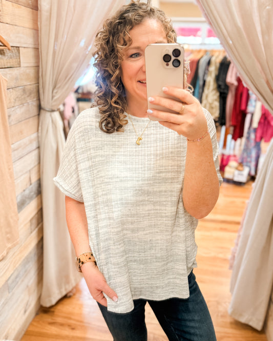 A light heathered gray loose fit short sleeve ribbed style top