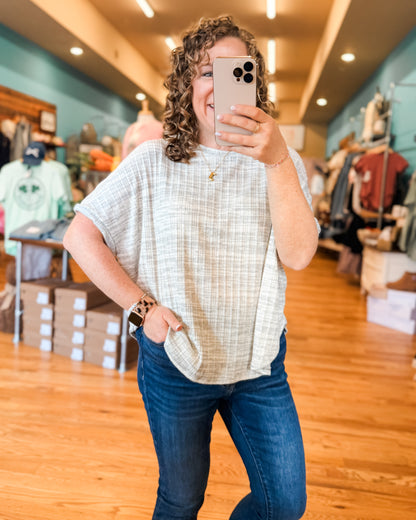 A lightweight heathered gray top with short sleeves and ribbed style 