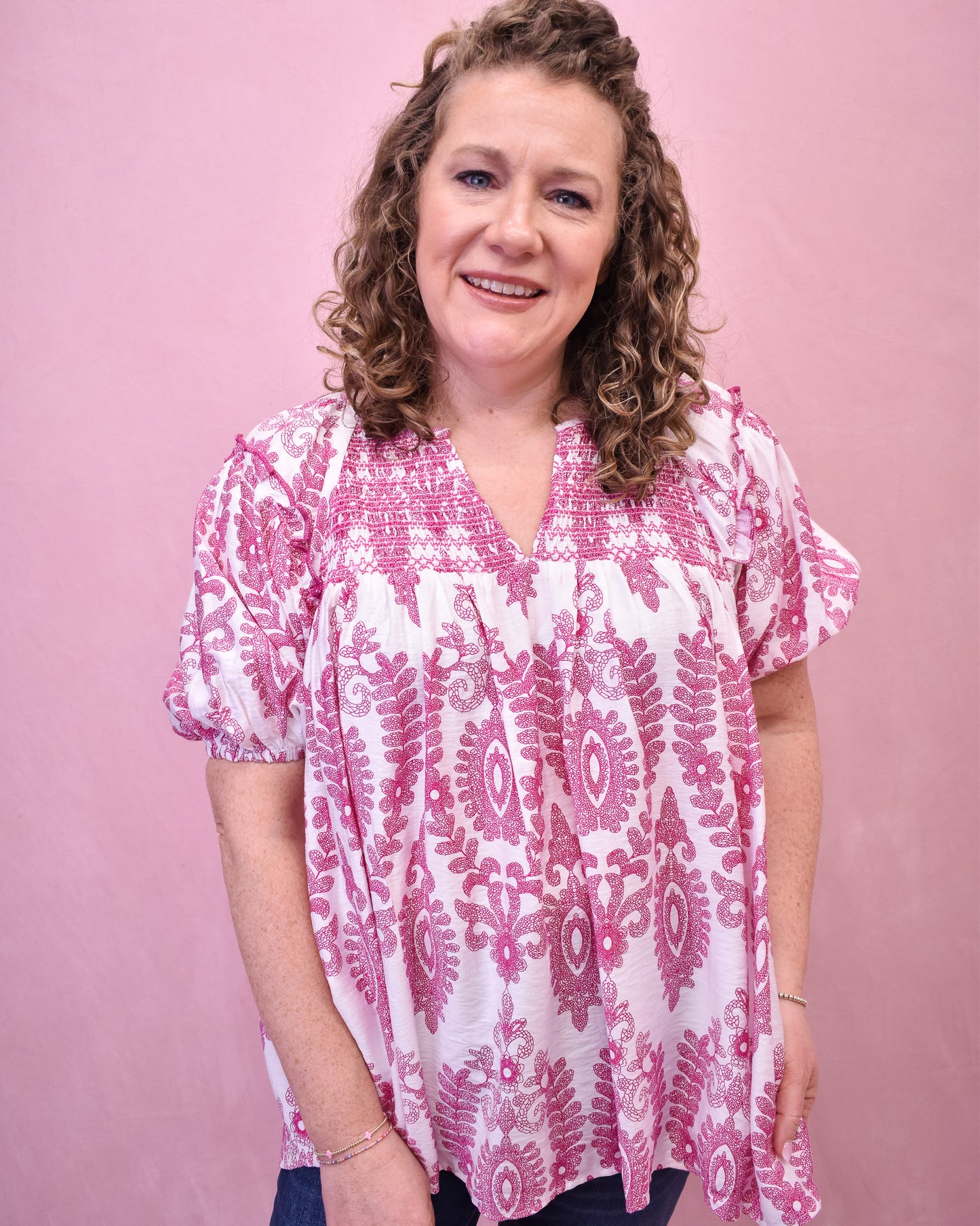 White short sleeve top with pink embordered details