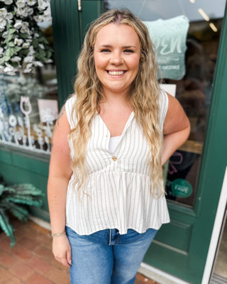 a sleeveless striped peplum button front top