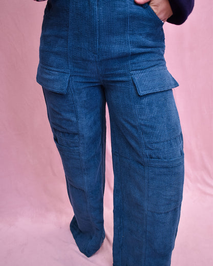 Blue corduroy pants on a pink background