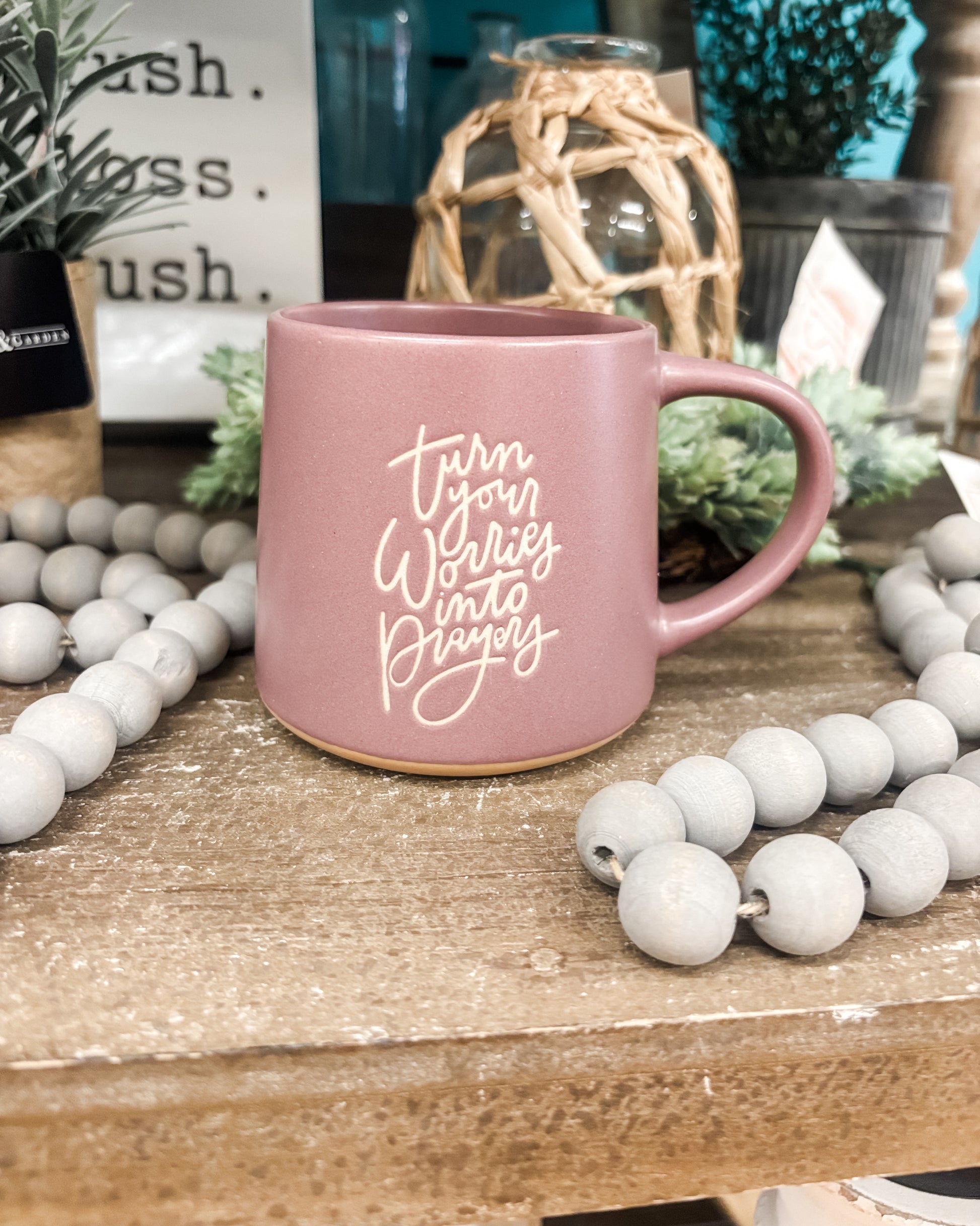 A mauve colored stoneware 16oz coffee mug