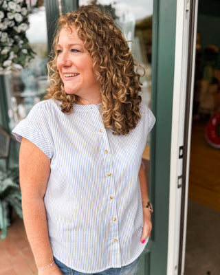 a short cap sleeve button down top in light blue