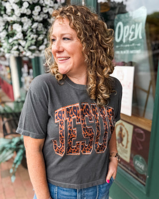 a black crop baby tee with JESUS leopard print graphic