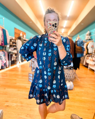 A Floral Whimsy Drop Hem Mini Dress - The Southern Loft