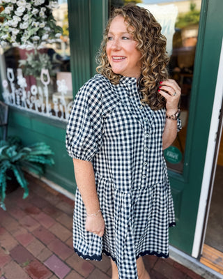 Gingham & Gatherings Ric Rac Trim Dress. A drop hem button front dress in a navy.