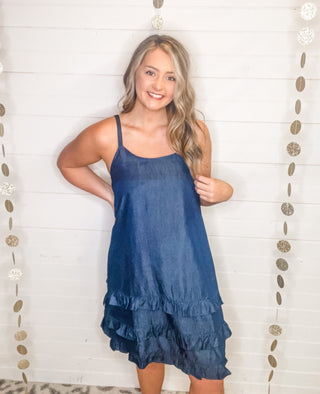 a sleeveless denim sun dress with ruffle hem